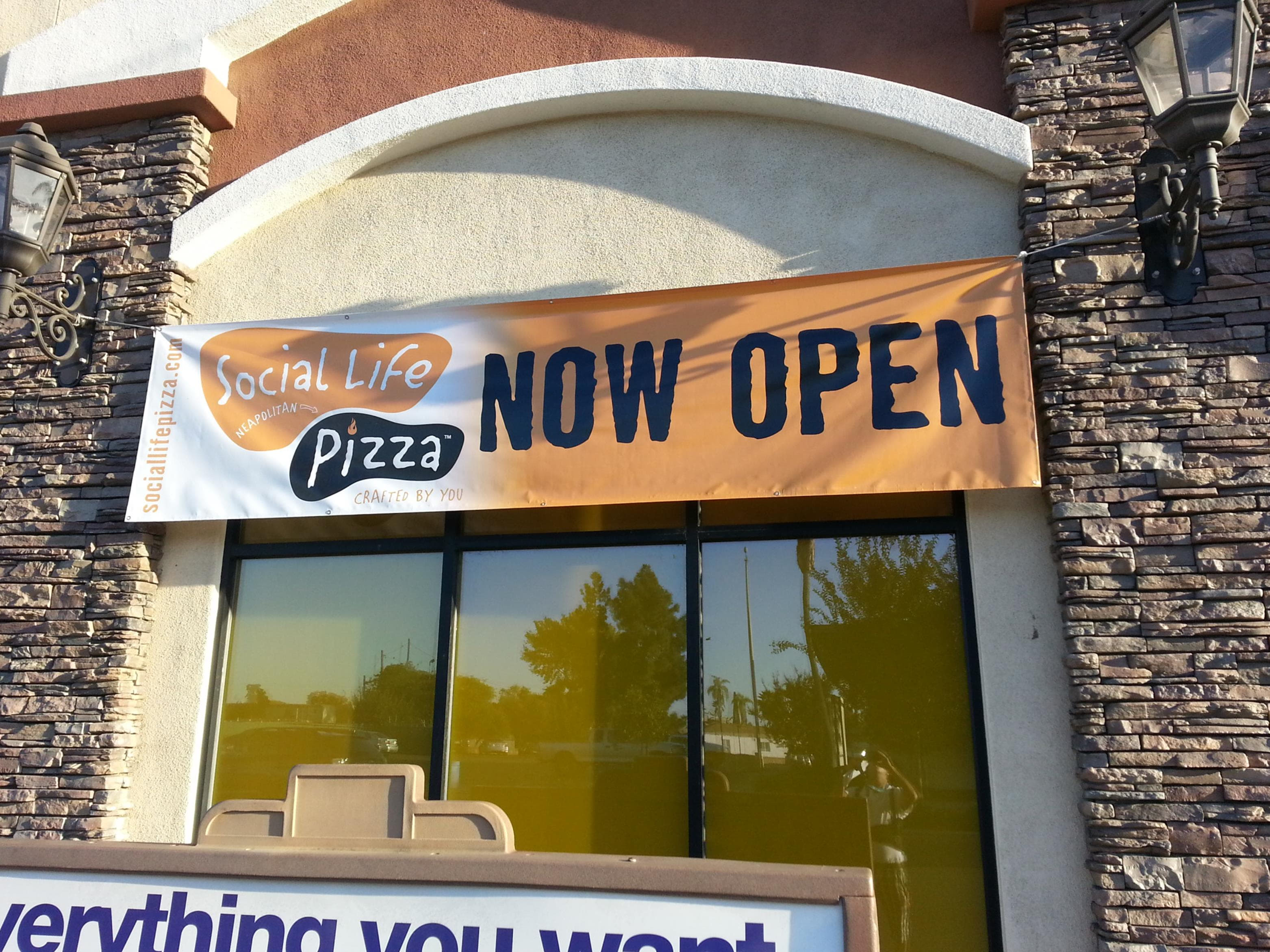 A pizza banner advertising its grand opening