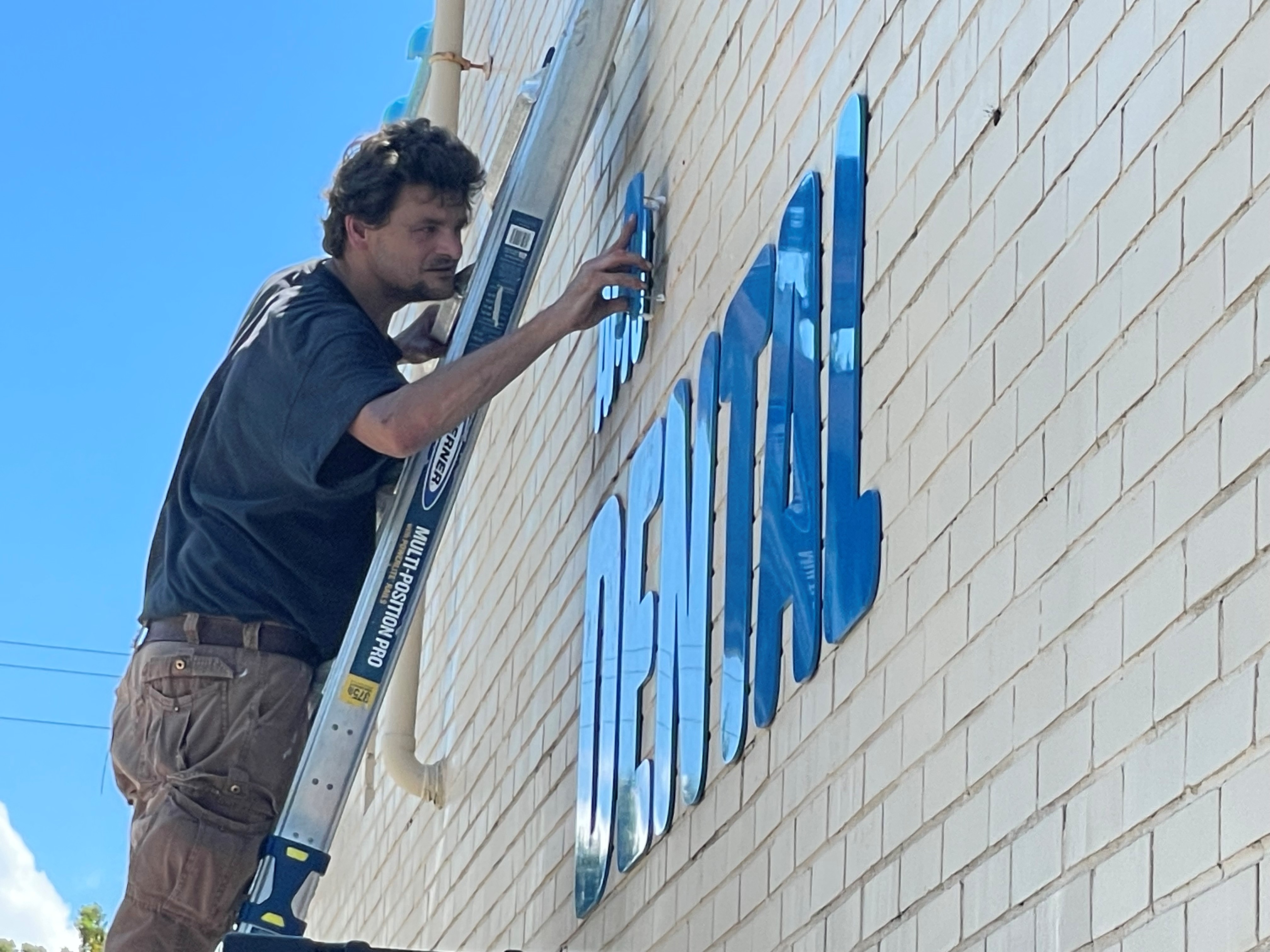 Amoah applying a new sign