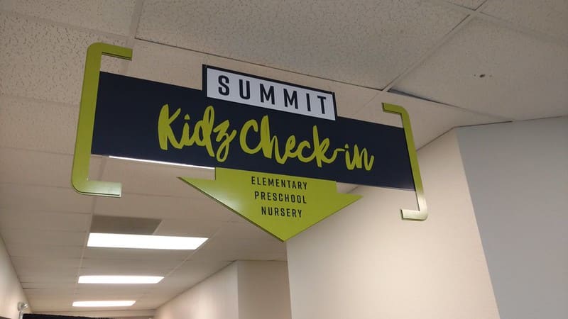 Overhang signage for a security check-in at a school