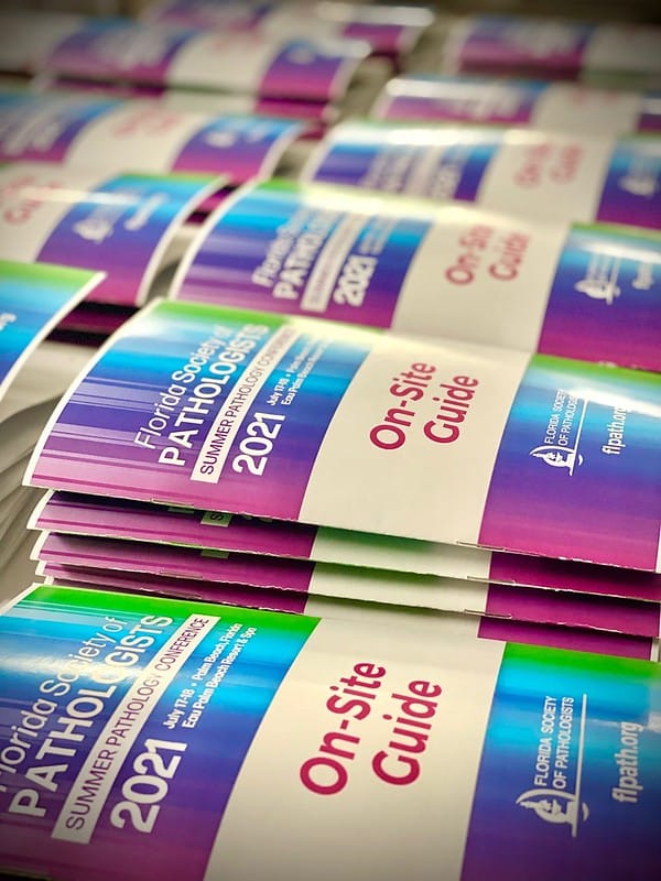 Stacks of on site guides for a conference
