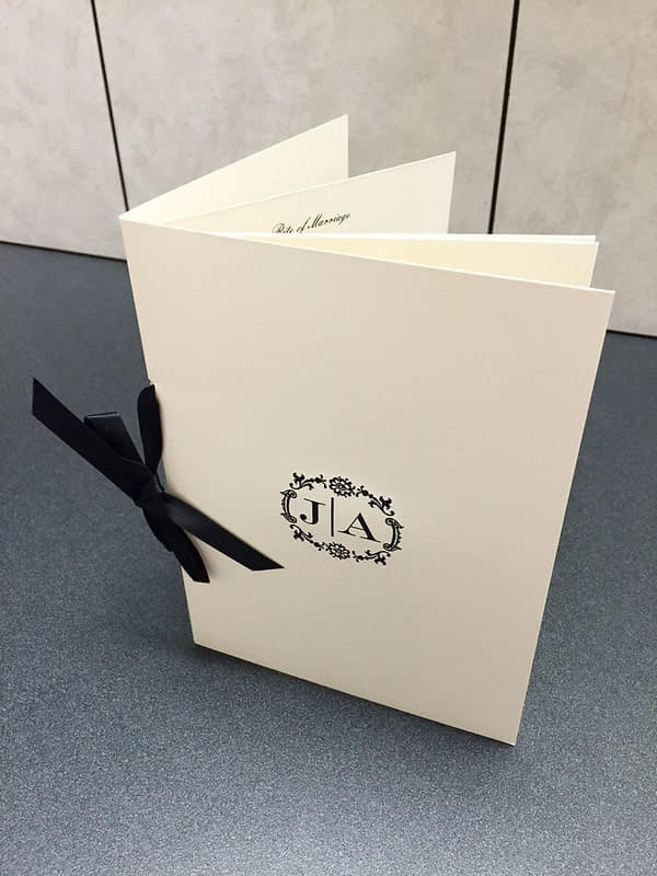 A marriage invitation with a bow binder