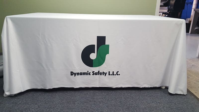 A booth table with a custom tablecloth